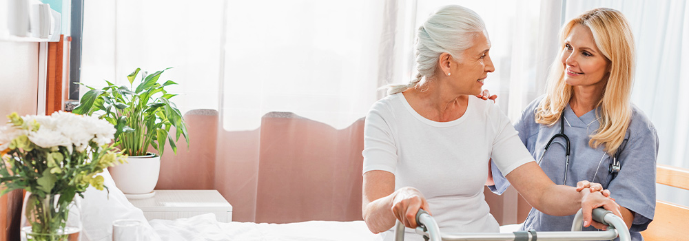 elderly woman being assisted by nurse