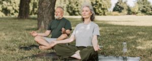 couple doing yoga in a park