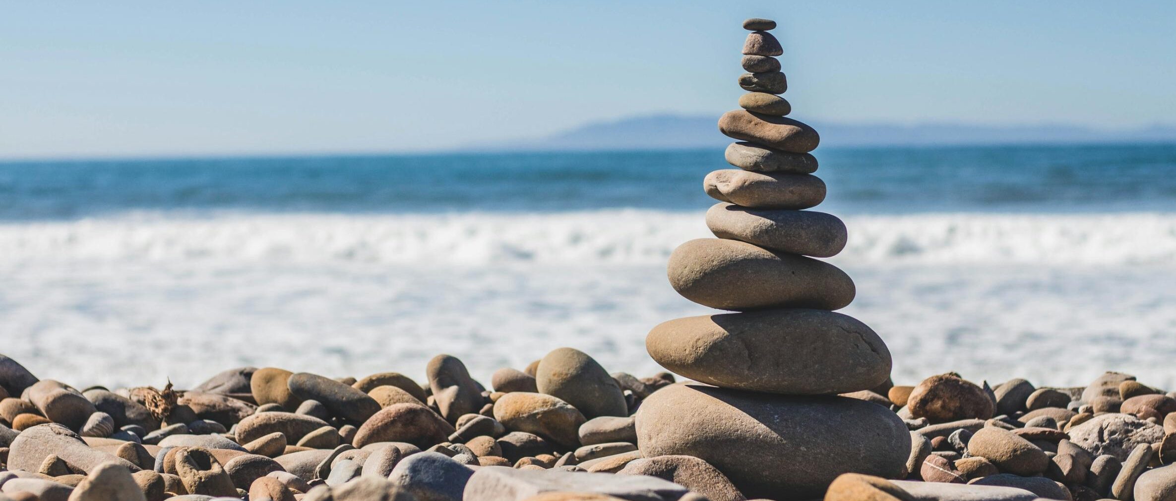stacked rocks by an ocean