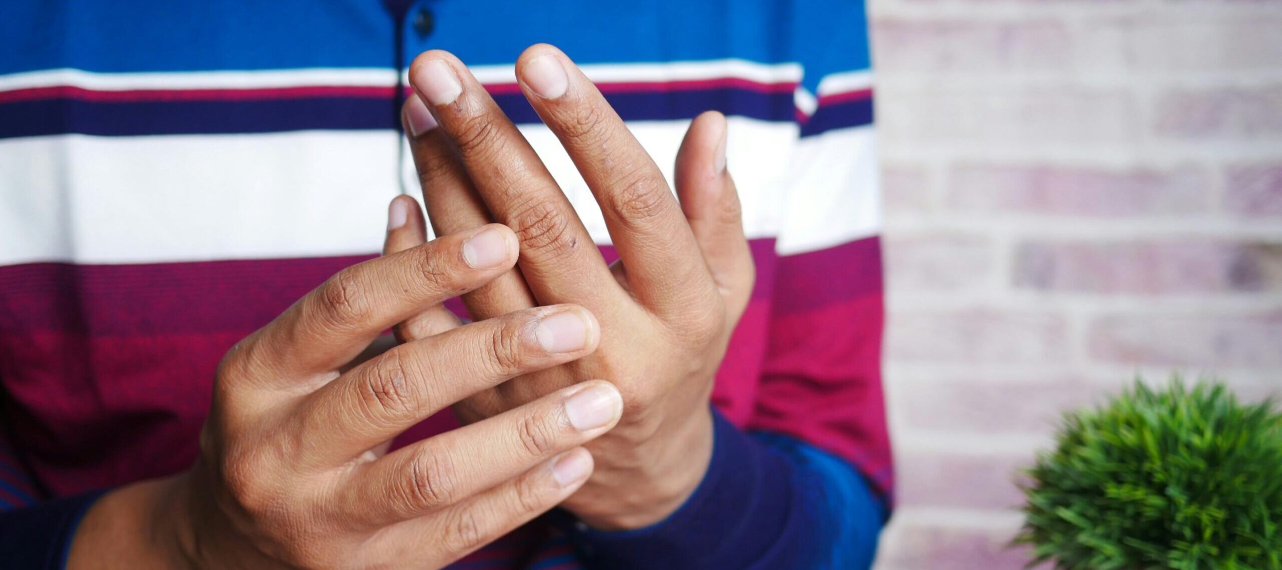 man suffering pain in hand close up